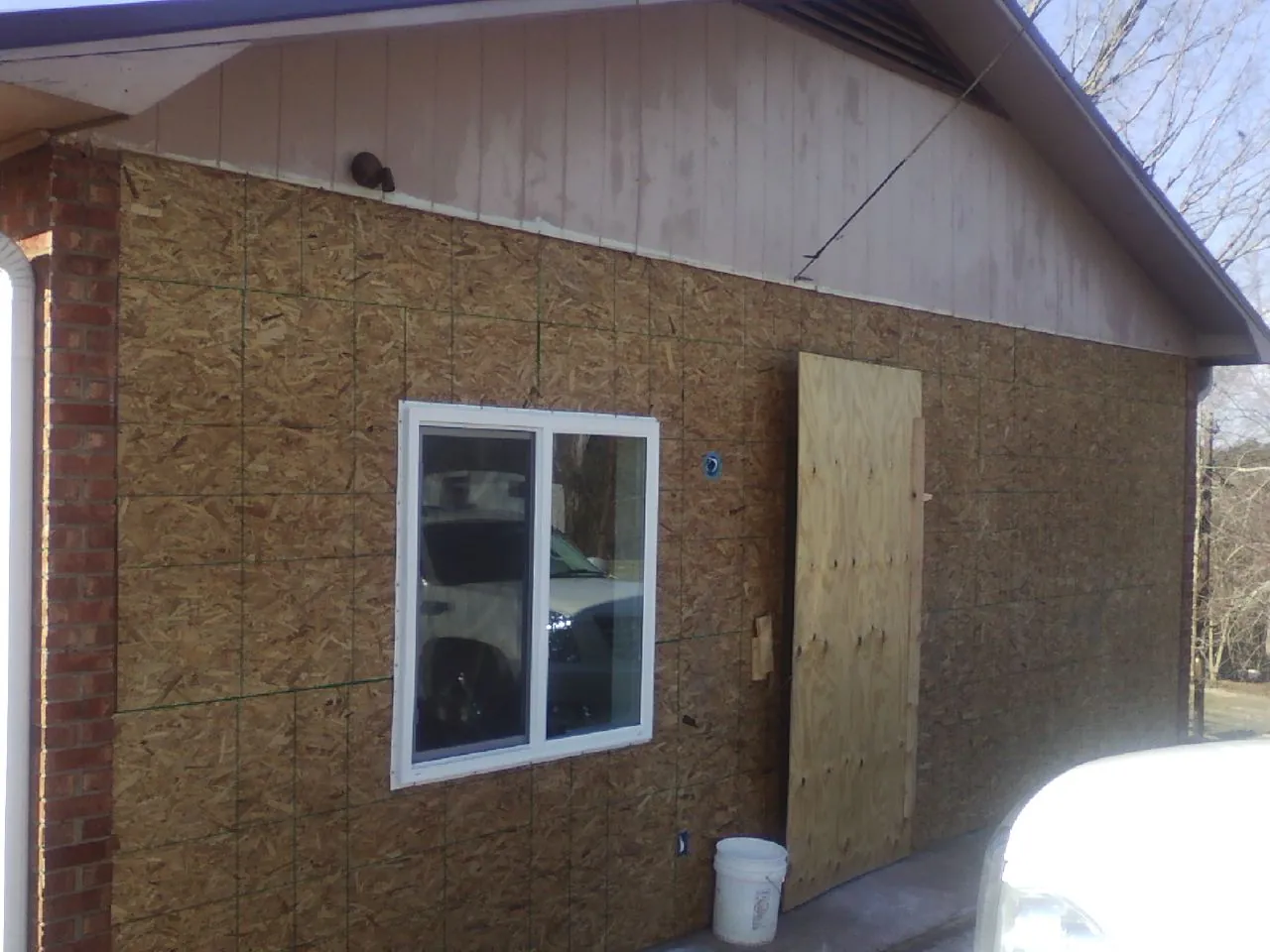 OSB sheathing on a garage addition wall before siding in Jackson